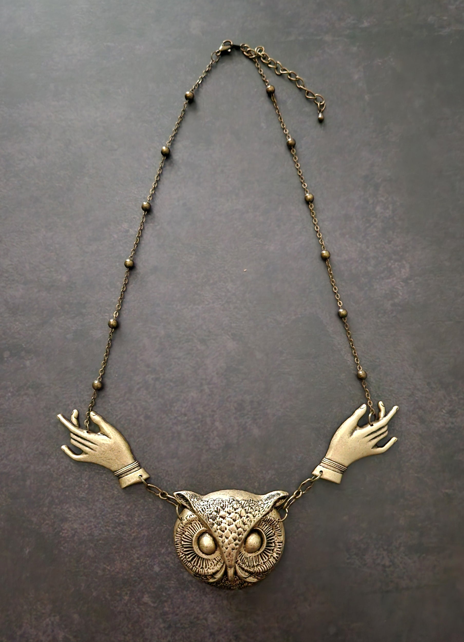 giving hands owl necklace